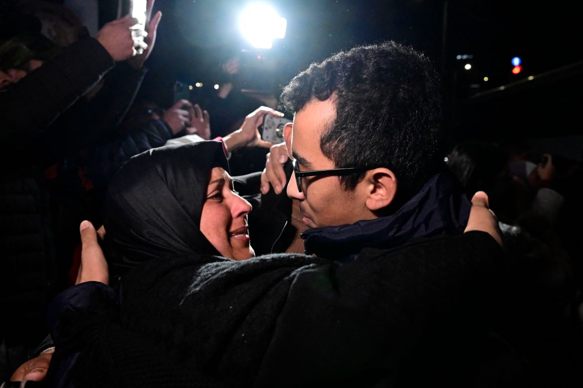 A newly released prisoner (R) greets a relative during a welcome ceremony following the release of Palestinian prisoners from Israeli jails in exchange for Israeli hostages held in Gaza by Hamas.