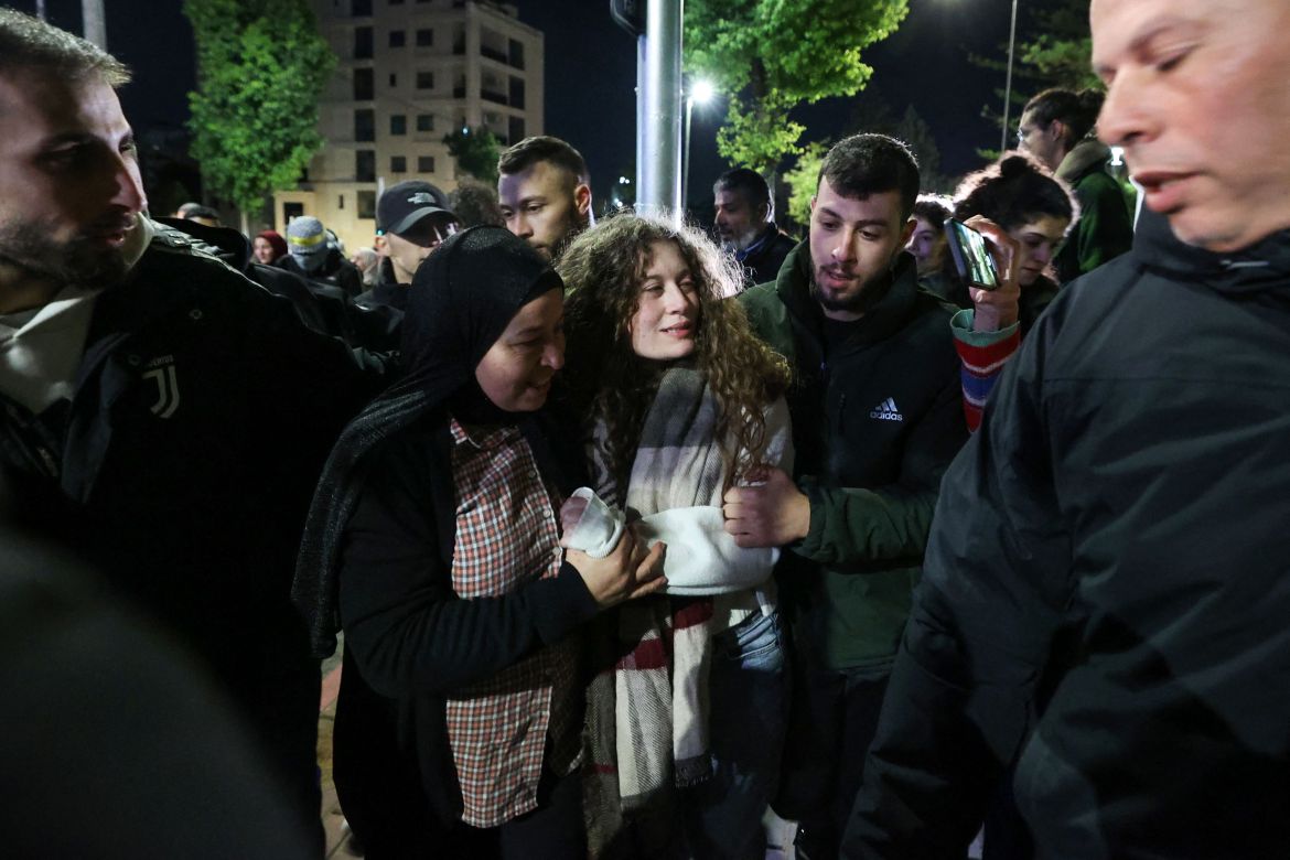 Newly released activist Ahed Tamimi (R) walks alongside her mother during a welcome ceremony following the release of Palestinian prisoners from Israeli jails in exchange for Israeli hostages held in Gaza by Hamas.