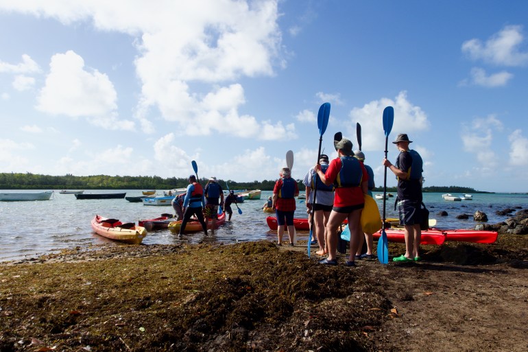 A group of German tourists prepare for their kayaking expedition to Île d’Ambre, an islet off the north-eastern coast of Mauritius