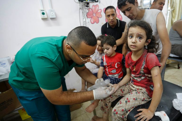 Doctors treat injured children in Israeli attacks at Al-Aqsa Martyrs Hospital in Deir Al Balah, Gaza