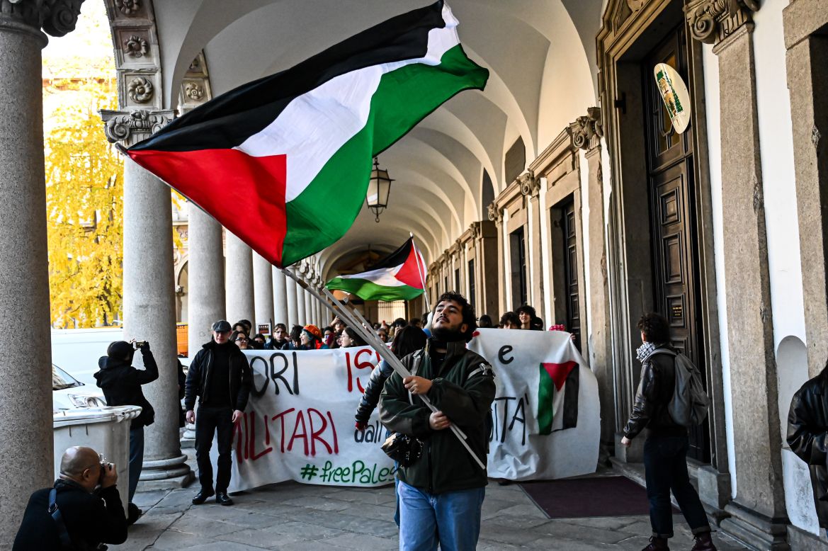 Students wave Palestinian flags and hold a banner reading 'Out Israel and military from the University' inside the University of Milan in solidarity with Palestine and to ask the University to sever ties with Israeli institutions and military industries in Milan, Italy.