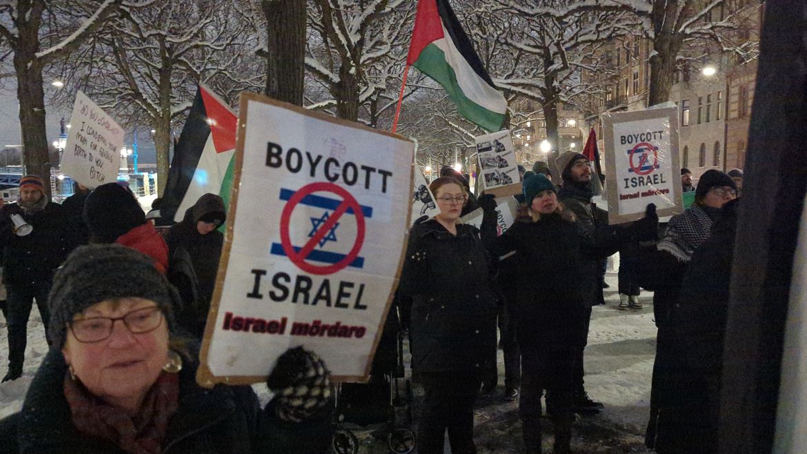 People, holding banners and Palestinian flags, gather to stage protest against Israeli attacks on Gaza on November 29, 2023 in front of Israeli Embassy in Stockholm, Sweden.