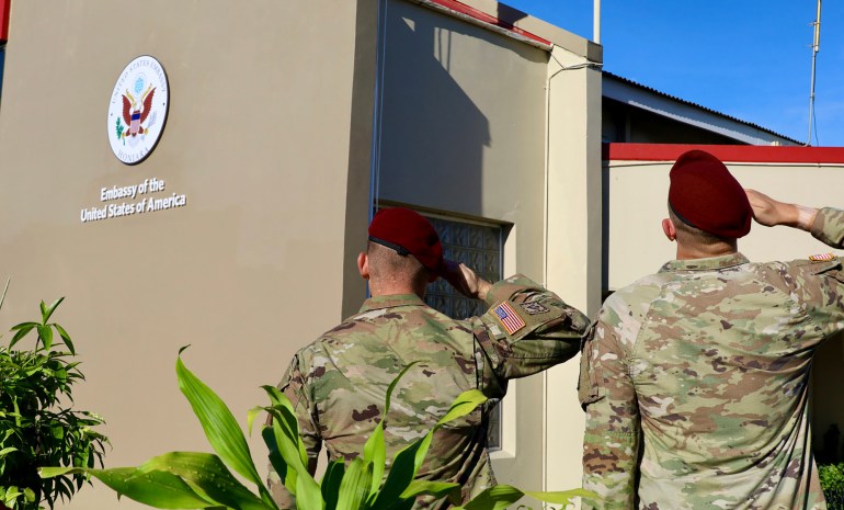 Two US soldiers saluting outside the newly opened embassy in Honiara.
