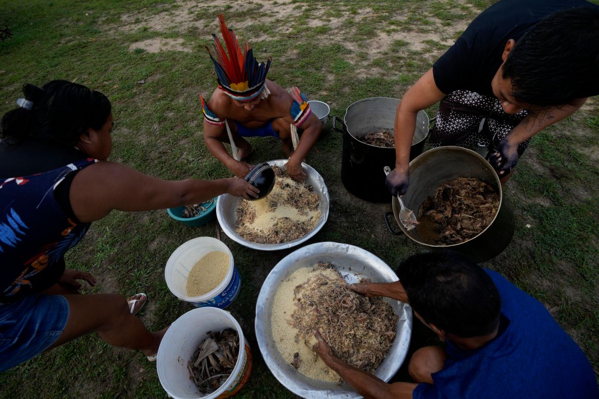 Indigenous Tembe prepare food for their community in the Tenetehar Wa Tembe village in the Alto Rio Guama Indigenous territory in the Paragominas municipality of the Para state of Brazil.