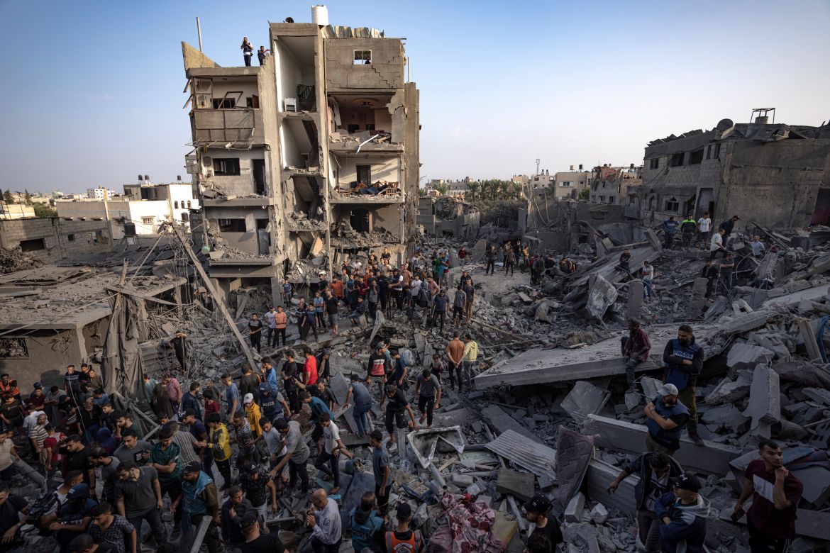 Palestinians look for survivors of the Israeli bombardment in the Maghazi refugee camp in the Gaza Strip, Sunday