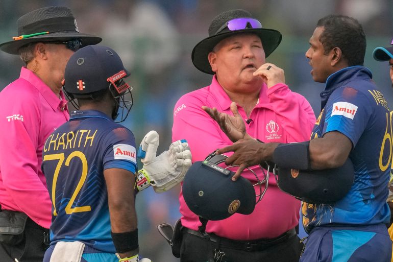 Sri Lanka's Angelo Mathews, right, talks to umpires after he was declared timed out during the ICC Men's Cricket World Cup match between Bangladesh and Sri Lanka in New Delhi, India, Monday, Nov. 6, 2023. Mathews who wasn’t ready to face his first ball within the stipulated two minutes became the first batter to be timed out in international cricket as the strap of his helmet appeared to be broken and he called for a replacement helmet. (AP Photo/Manish Swarup)