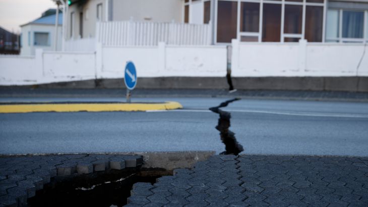 A fissure stretches across a road in the town of Grindavik, Iceland.