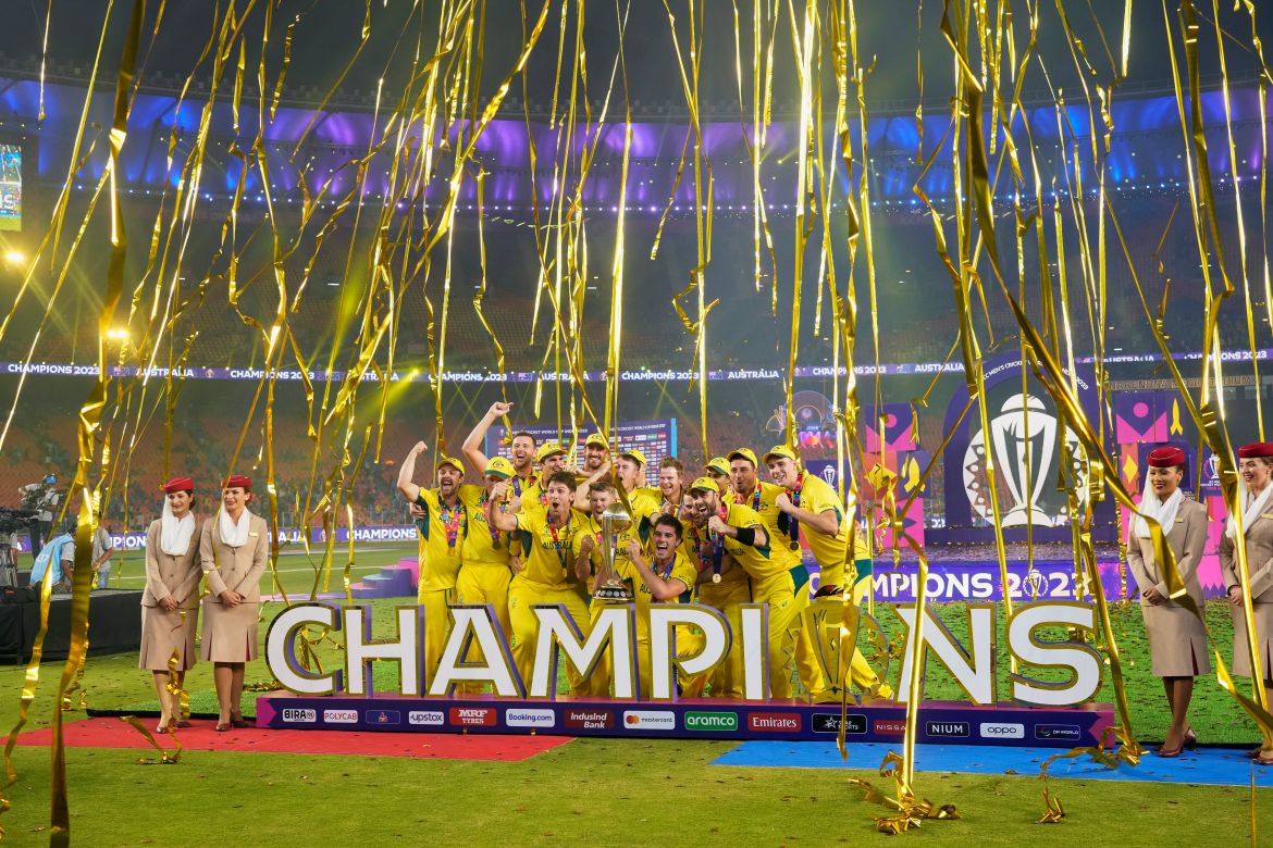 Australia players celebrate with the trophy after Australia won the ICC Men's Cricket World Cup final match against India in Ahmedabad, India.