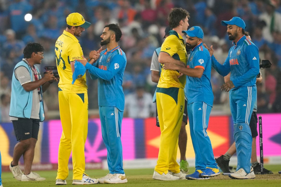 Australia's captain Pat Cummins, left, talks to India's Virat Kohli after Australia won the ICC Men's Cricket World Cup final match against India in Ahmedabad, India.