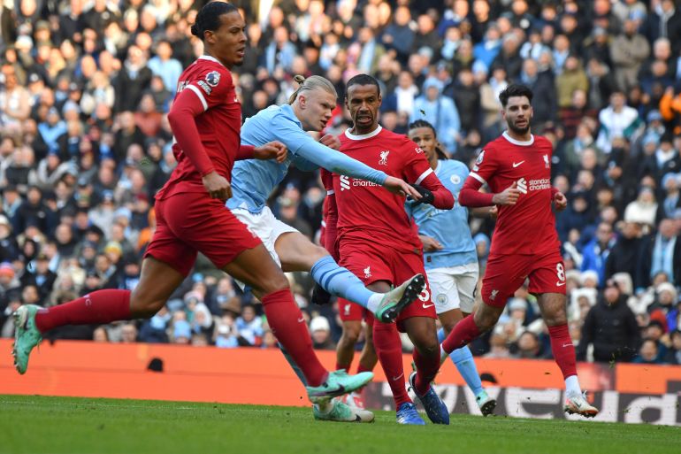 Manchester City's Erling Haaland scores his side's opening goal during the English Premier League soccer match between Manchester City and Liverpool at Etihad stadium in Manchester