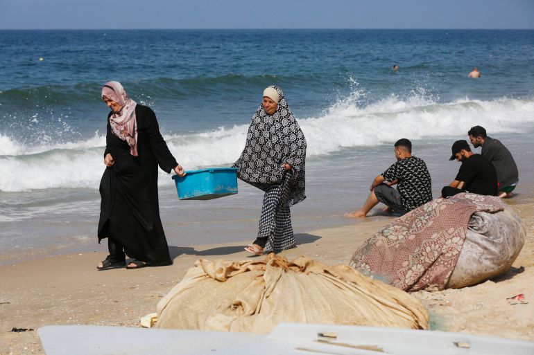 Palestinians using the sea to wash their clothes and bathe
