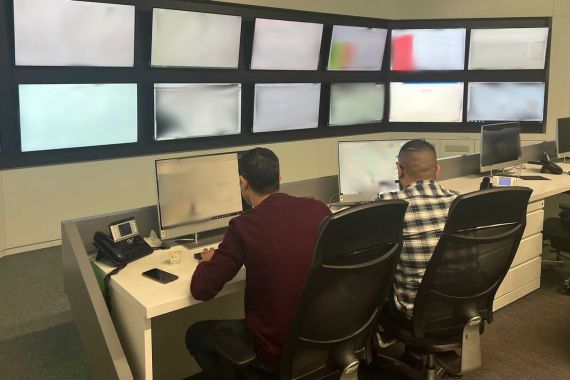 Engineers sitting at computers, with screens full of network info in front of them