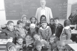 Jeremy Corbyn poses for a photo with Palestinian school children in a classroom in Gaza [Courtesy of Jeremy Corbyn]