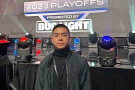 Khai Wu stands in front of a PFL sign