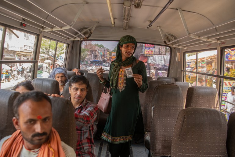 Leeza Khan, a transgender beggar in Delhi, India, carries a QR code for commuters to scan and donate to her