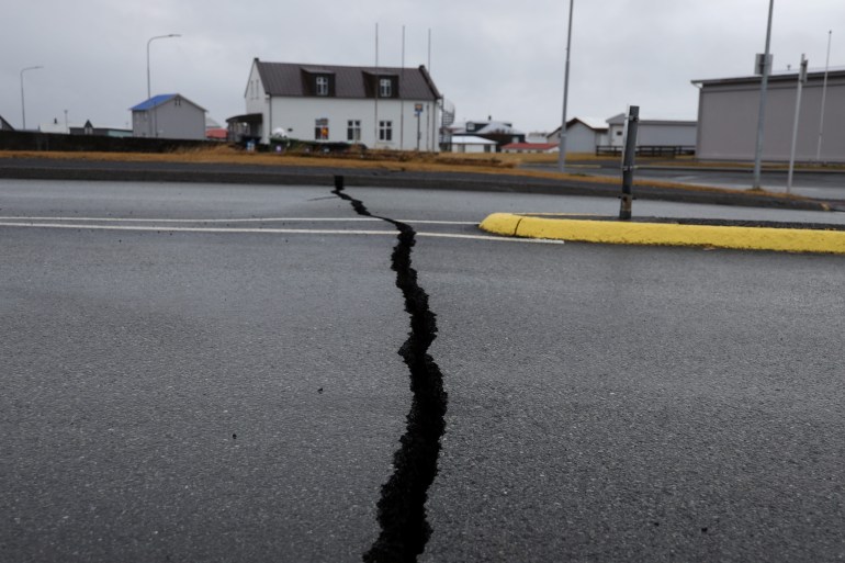 Cracks emerge on a road due to volcanic activity near a police station, in Grindavik, Iceland November 11, 2023. [RUV/Ragnar Visage/Handout via Reuters] 
