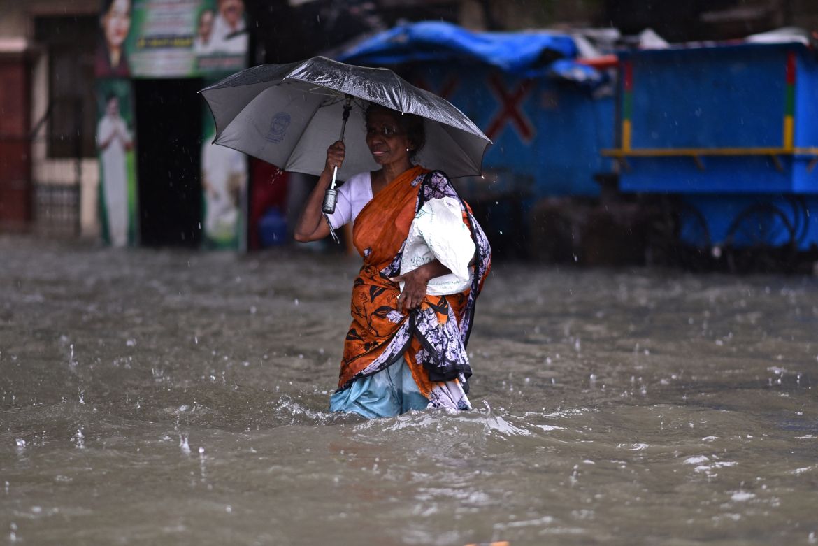 A woman wades through a flooded road during heavy rains as Cyclone Michaug is expected to make landfall on the eastern Indian coast, in Chennai, India, 04 December