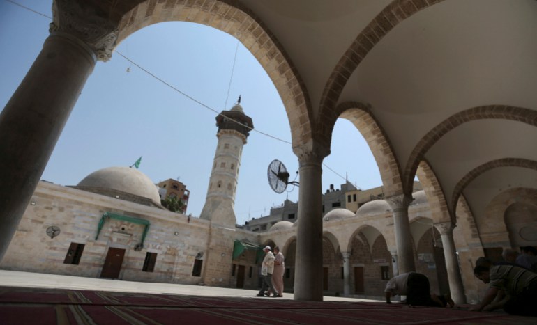 Palestinians pray at al Omari mosque in Gaza