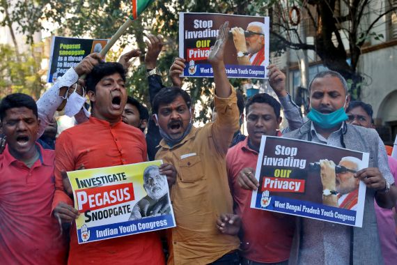 Supporters of India's main opposition Congress party hold placards as they shout slogans against India's Prime Minister Narendra Modi during a protest against what they say is use of Pegasus to spy on activists, journalists and politicians, in Kolkata, India,
