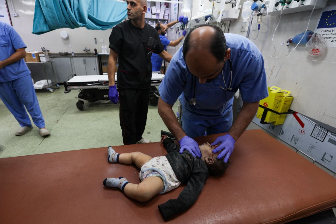 A medical worker assists a wounded Palestinian baby at Nasser hospital, following Israeli strikes, amid the ongoing conflict between Israel and the Palestinian Islamist group Hamas, in Khan Younis in the southern Gaza Strip, December 4