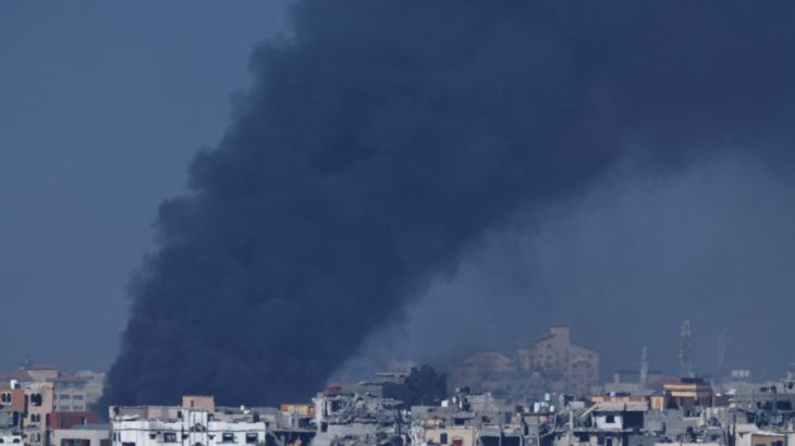 Smoke rises over Gaza, amid the ongoing conflict between Israel and the Palestinian Islamist group Hamas, as seen from southern Israel, December 11