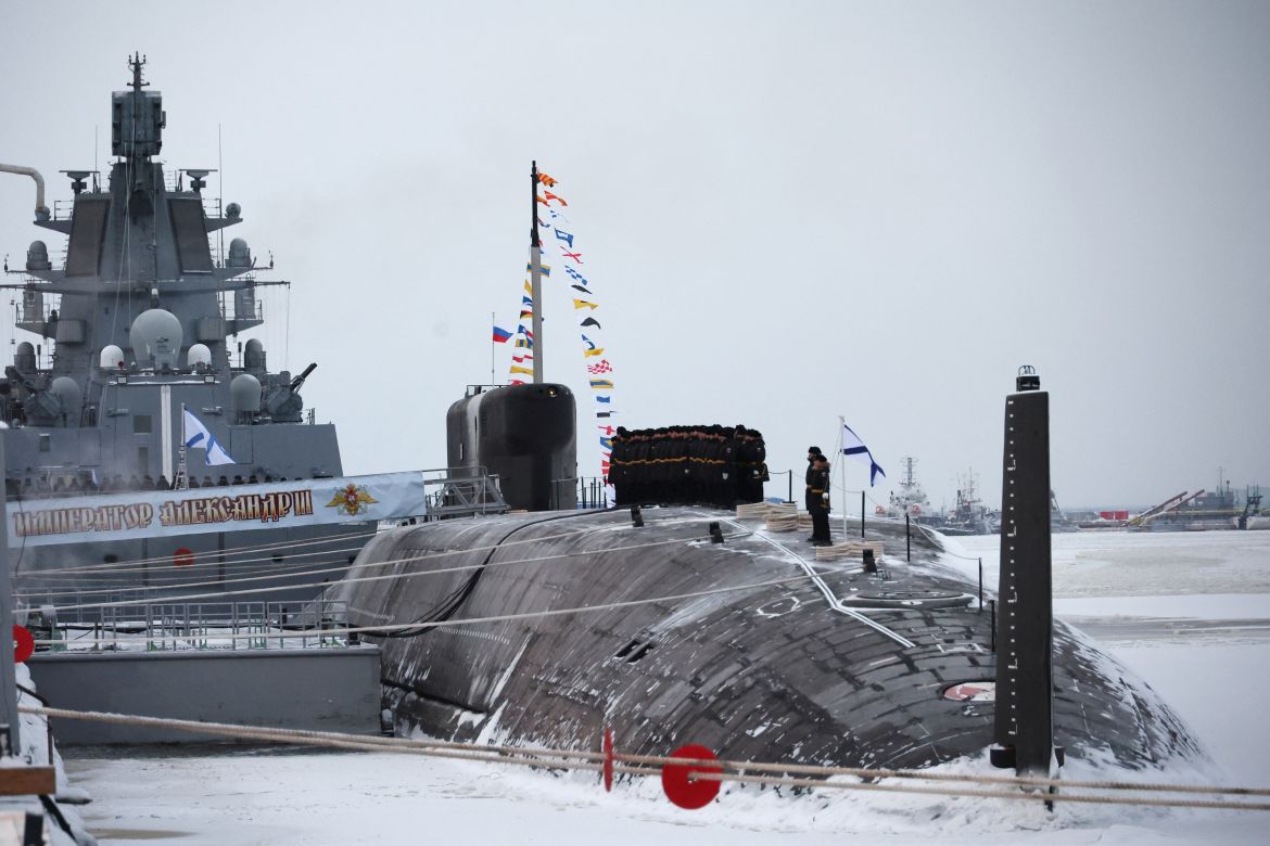 the nuclear-powered submarine Emperor Alexander with a naval ship behind it