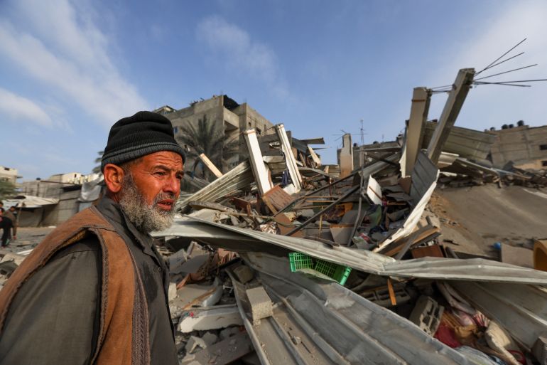 A Palestinian man inspects the damage at the site of Israeli strikes on houses, amid the ongoing conflict between Israel and Hamas.