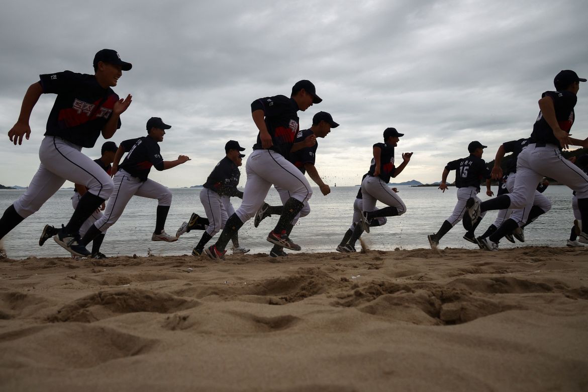 Members of the Deokjeok High School baseball team run on a beach during a practice session, on Deokjeok island in Incheon, South Korea.