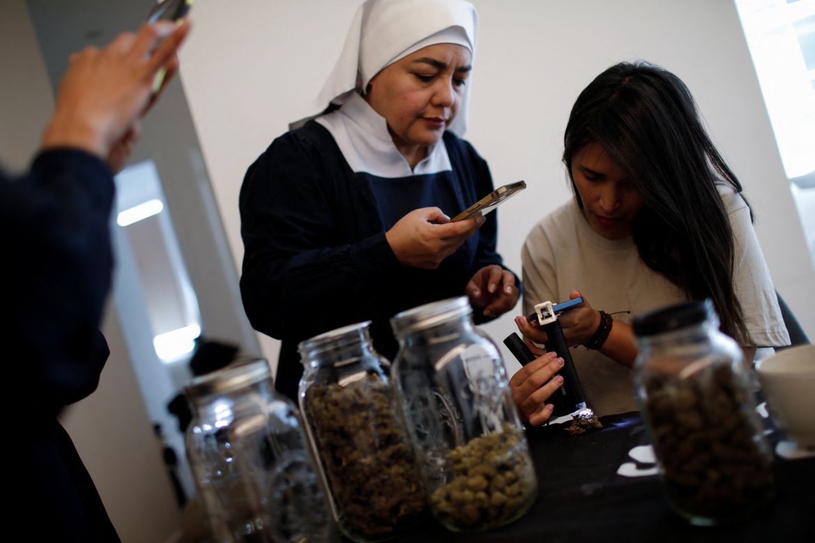Members of Sisters of the Valley, a non-religious international group founded in 2014 which has pledged to spread the gospel of the healing powers of cannabis, who use the monikers "Sister Maru" and "Sister Bernardet" online and asked not to give their names for fear of reprisal, and Alehli Paz (R), 34, a chemist and marijuana researcher working with the group, check dry hemp at a house in Mexico City, Mexico, December 3, 2023.