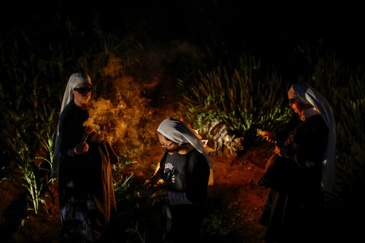 Members of Sisters of the Valley, a non-religious international group founded in 2014 which has pledged to spread the gospel of the healing powers of cannabis, who use the monikers "Sister Kika", "Sister Bernardet" and "Sister Yeri" online and asked not to give their names for fear of reprisal, smoke joints during a full moon ritual at the Sisters of the Valley's farm on the outskirts of a village in central Mexico, September 2, 2023.
