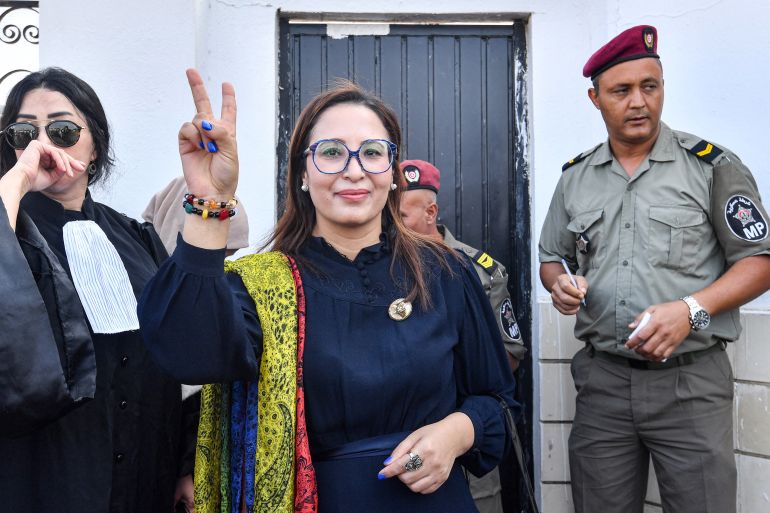 Chaima Issa, member of Tunisia's "National Salvation Front" opposition coalition, gestures as she arrives outside a military court in Tunis on October 3, 2023. - Issa had been freed from jail late on July 13 after spending more than five months in custody. The Tunisian writer was arrested in February along with former minister and lawyer Lazhar Akremi on charges of "conspiracy against state security". (Photo by FETHI BELAID / AFP)