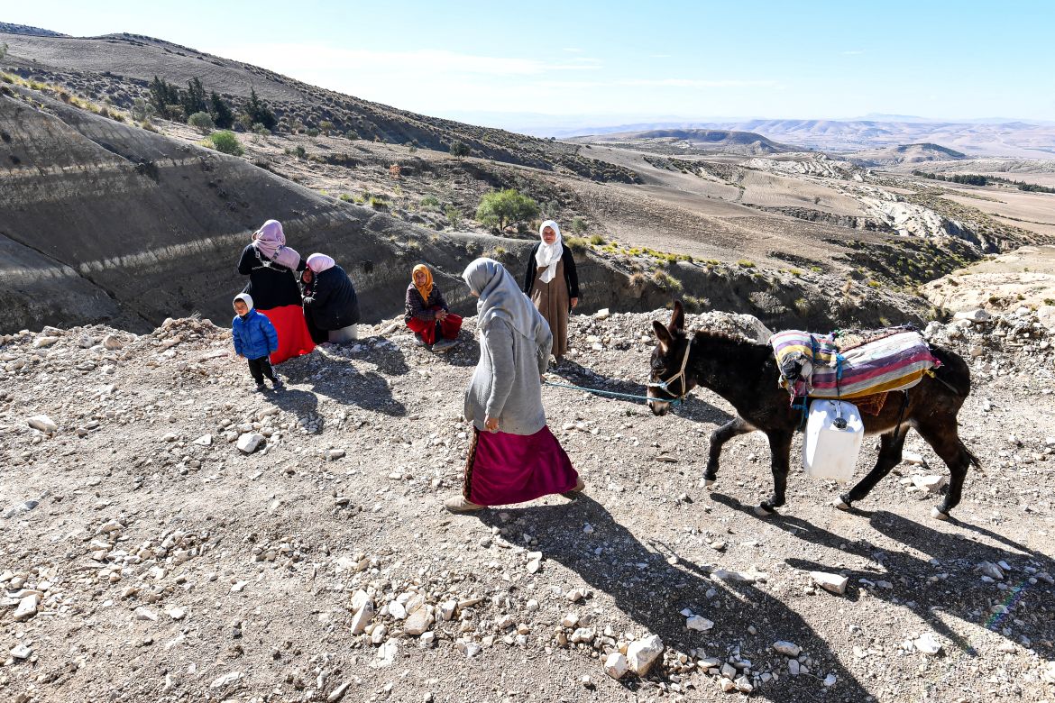 A Tunisian farmer transports water she filled up from a river on the back of a donkey in the remote village of Ouled Omar, 180 kilometres southwest of the capital Tunis.