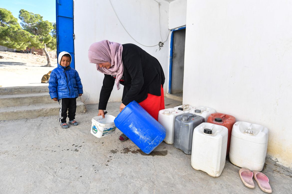 A Tunisian woman prepares water for her laundry in the remote village of Ouled Omar, 180 kilometres southwest of the capital Tunis, on November 28, 2023, as the north African country grapples with its worst water scarcity in years as it enters its fourth year of drought.