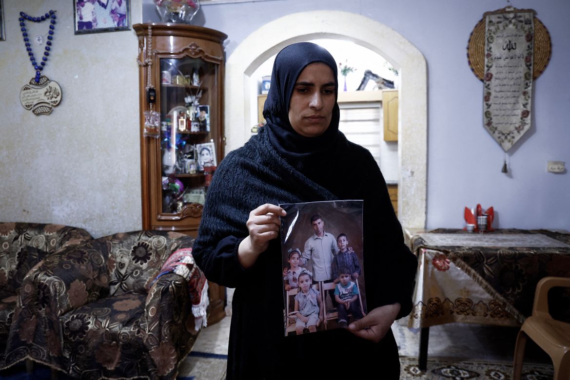 The wife of Palestinian Bilal Saleh shows a picture her late husband at the village of As-Sawiyah, south of Nablus in the occupied West Bank.