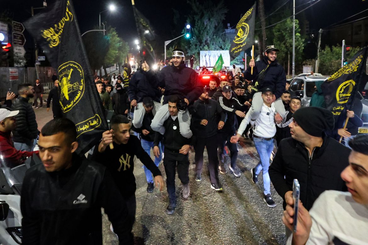 Newly released prisoners are carried by supporters holding the flag of militant group Islamic Jihad, during a welcome ceremony following the release of Palestinian prisoners from Israeli jails.