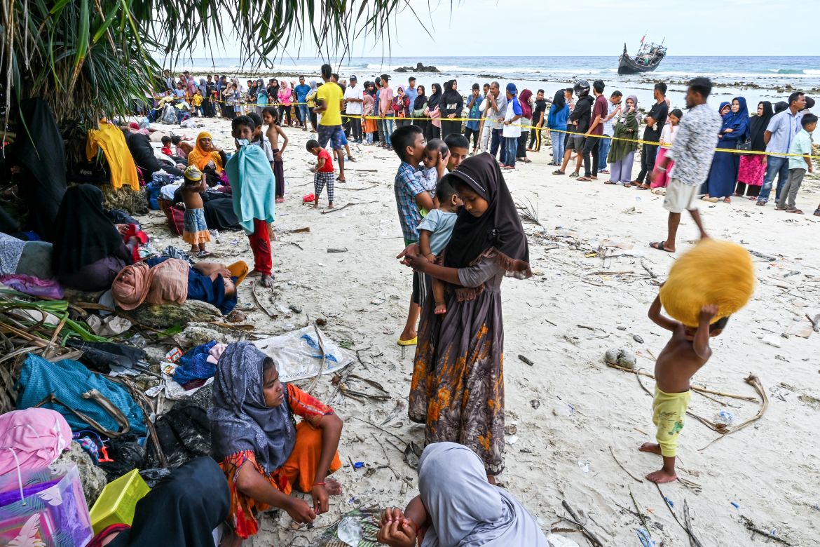 Newly-arrived Rohingya refugees rest at a beach on Sabang island, Aceh province, on December 2