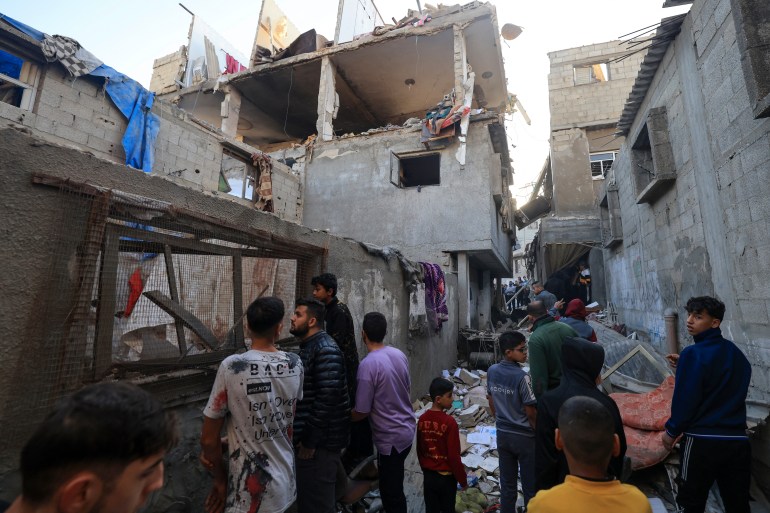 People check the damage in a house hit by Israeli bombing in Khan Yunis in the southern Gaza Strip on December 3