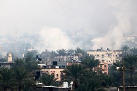 Smoke rises above buildings in Khan Yunis in the southern Gaza Strip, as battles between Israel and Hamas intensify in the south of Gaza on Tuesday [Mahmud Hams/AFP]