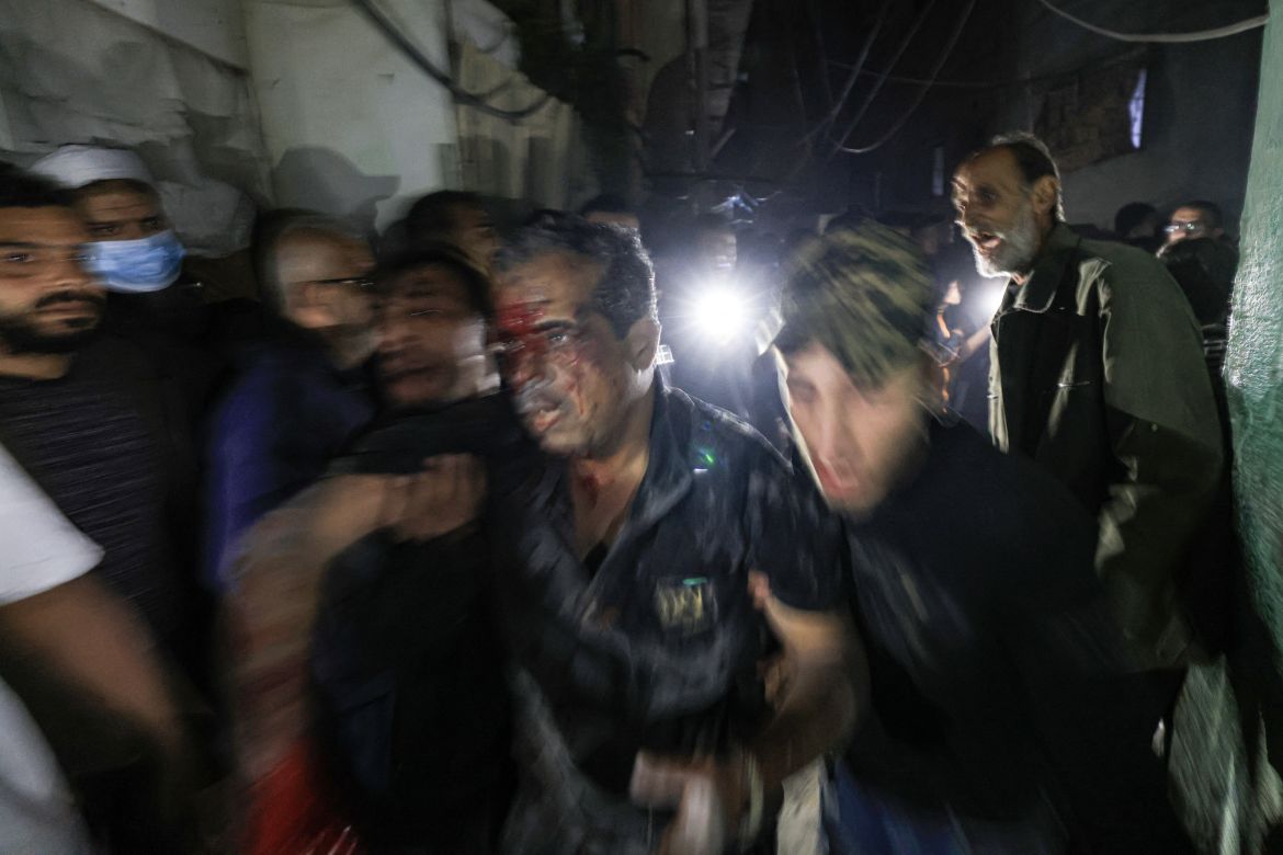 People help an injured man following an Israeli strike in Rafah in the southern Gaza Strip.