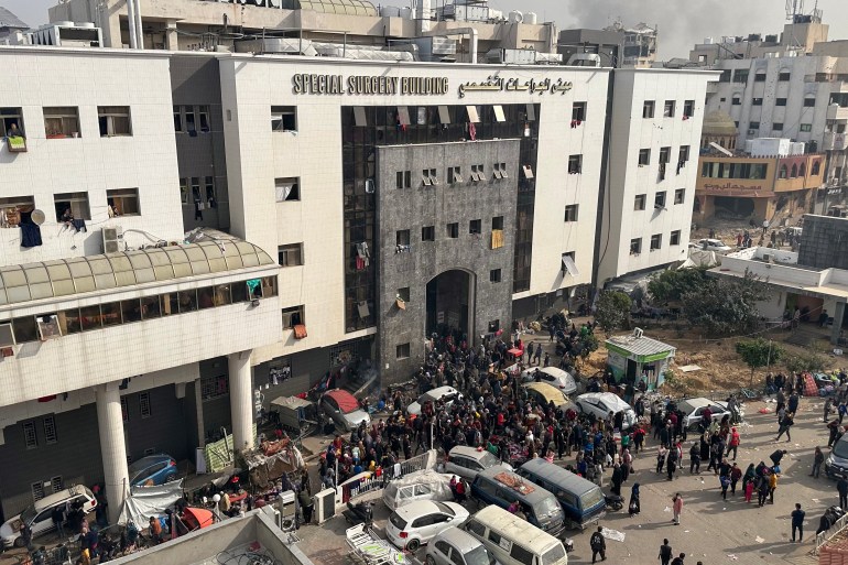 Displaced Palestinians gather in the yard of Gaza's Al-Shifa hospital on December 10