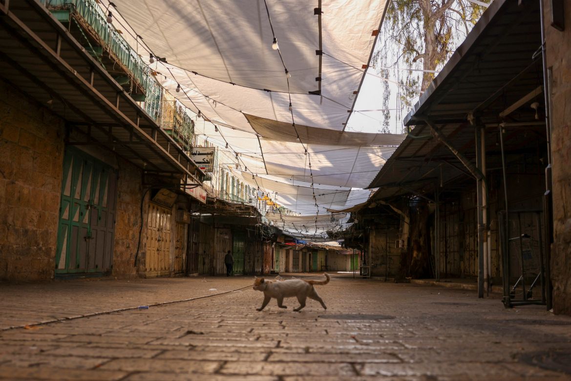 A picture shows shuttered shops during a general strike in solidarity with Gaza, in the occupied West Bank city of Hebron, on December 11