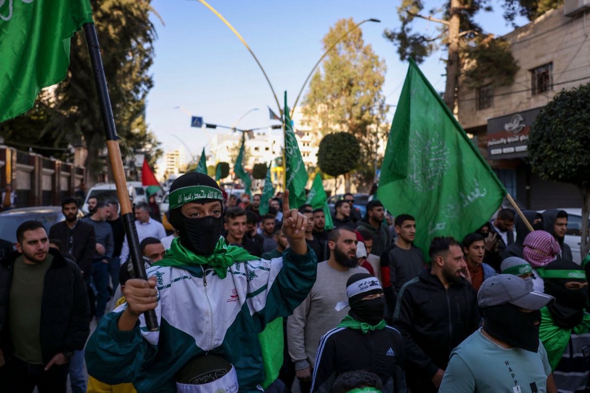 Palestinian protestors carry Hamas flags during a rally supporting the Gaza Strip amid ongoing battles between Israel and the Palestinian movement Hamas, on December 11