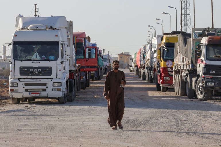 Trucks with humanitarian aid wait to enter the Palestinian side of Rafah on the Egyptian border with the Gaza Strip.