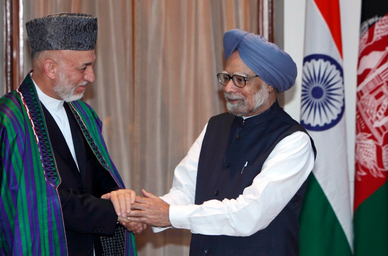 Indian Prime Minister Manmohan Singh, right, and Afghanistan President Hamid Karzai pose before a meeting in New Delhi, India, Tuesday, Oct. 4, 2011. Karzai is on a two-day official visit to India.(AP Photo/Gurinder Osan)