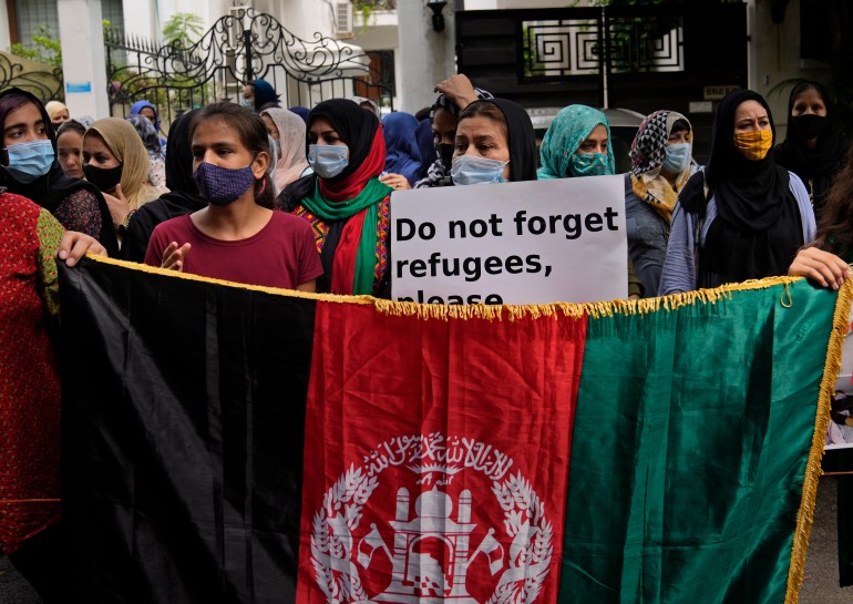 Afghans living in Delhi participate in a protest outside the UNHCR office (United Nation High Commissioner for Refugees) in New Delhi, India, Monday, Aug. 23, 2021. Hundreds of Afghans living in India gathered to protest against the Taliban takeover of Afghanistan and also demanded to be given refugee status in India. (AP Photo/Manish Swarup)