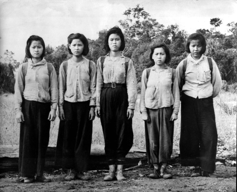 Young women, serving as cooks and nurses in the guerilla army un Liew Kin Kim, came out of the jungle to surrender in South Selangor, Malaysia, 1953. (AP Photo)