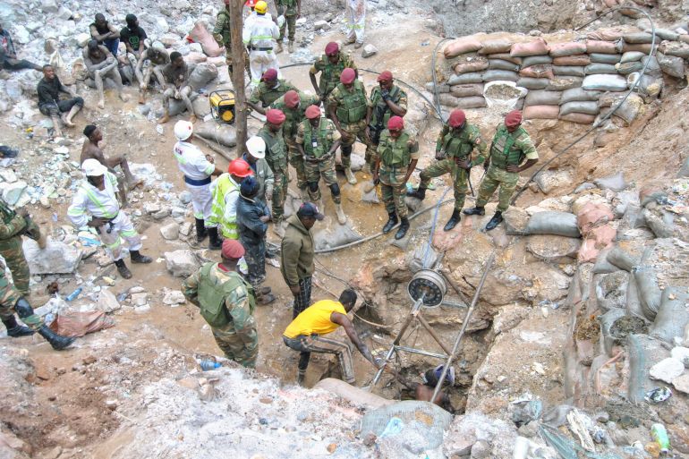 Zambian Army special forces officers follow the rescue operation of miners on Sunday