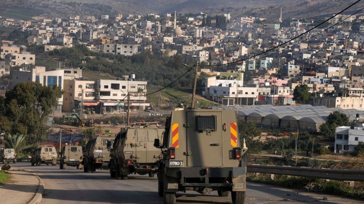 A convoy of Israeli army vehicles is seen during a military raid into Faraa refugee camp, West Bank
