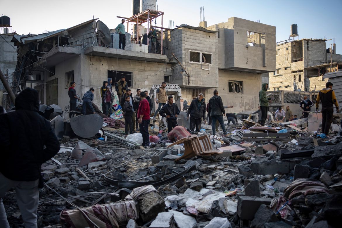 Palestinians look at houses destroyed in the Israeli bombardment of the Gaza Strip in Rafah.