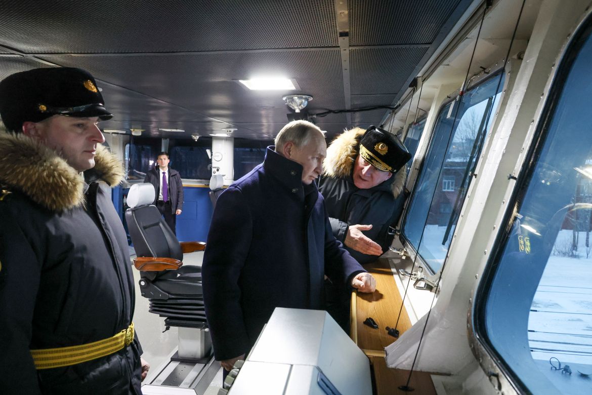 Russian President Vladimir Putin, center, and Admiral Nikolai Yevmenov, Commander-in-Chief of the Russian Navy, right, visit the newest frigate "Admiral of the fleet Kasatonov". They are on the ship's bridge.
